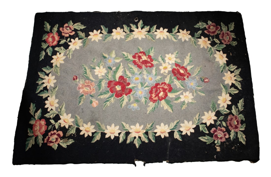 HOOKED RUG BLOSSOMS OVAL IN RECTANGLE MID 20TH C.: Polychrome Garden Flowers, oval in rectangle, grey center, black brackets.Size: 48 x 75 in. (121.9 x 190.5 cm.)