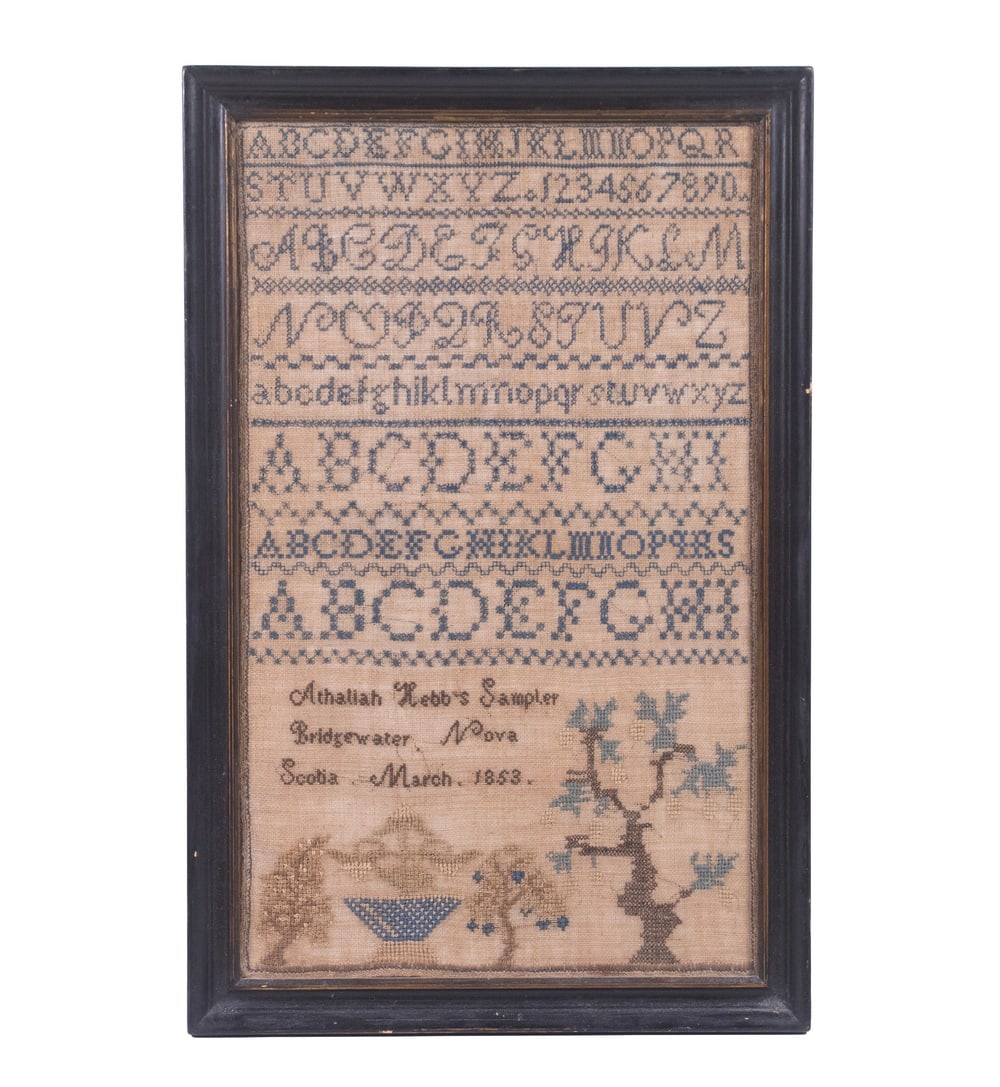ATHALIAH HEBB NOVA SCOTIA NEEDLEWORK SAMPLER, DATED 1853: A linen and wool needlework sampler featuring multiple alphabet bands, numerals, geometric borders, and a lower register with trees and a basket motif. Signed “Athalaih Hebb’s Sampler, Bri