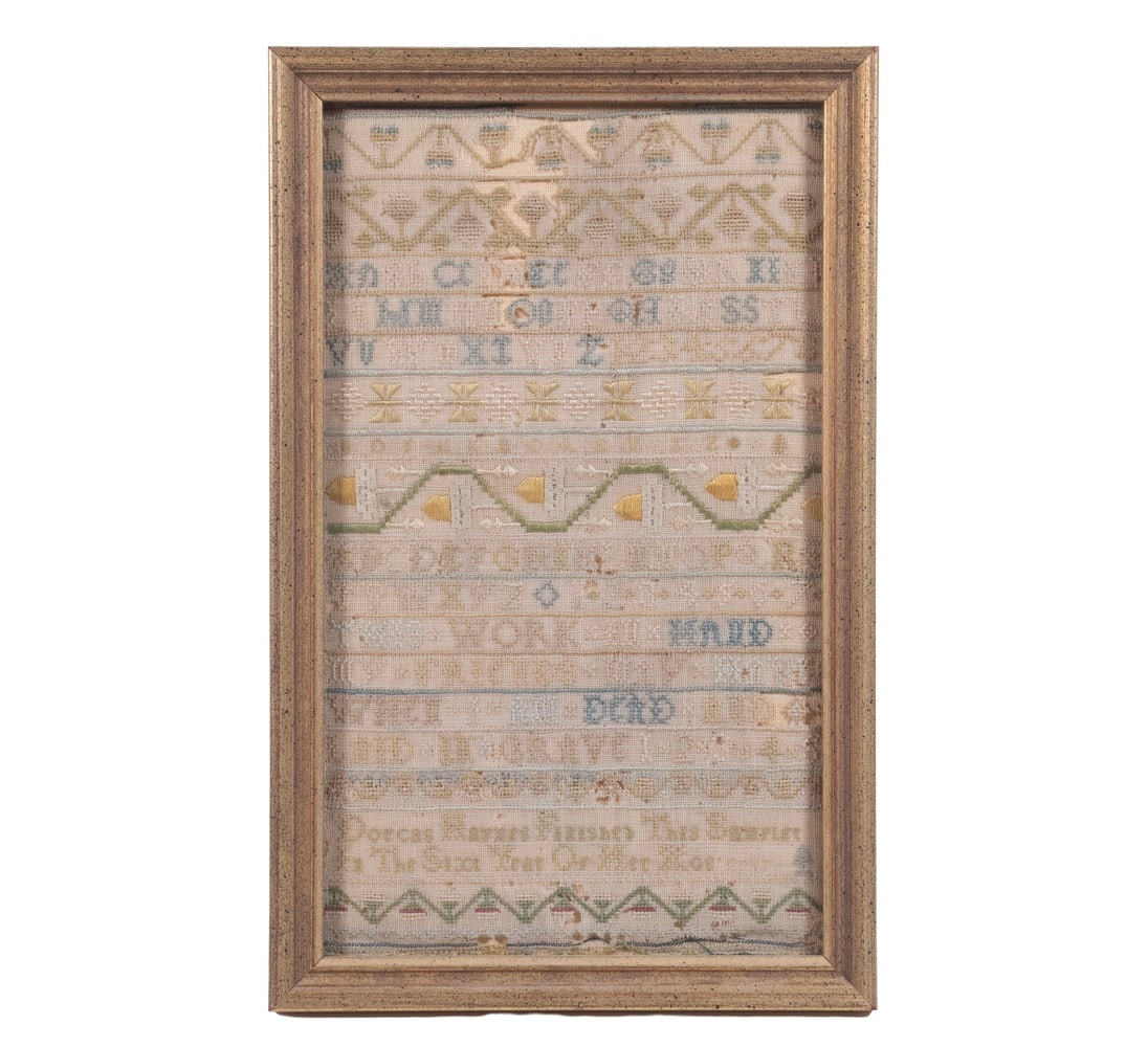 DORCAS HAYNES ENGLISH SAMPLER, DATED 1717: An English alphabet and verse sampler worked in silk on linen, displaying multiple rows of decorative borders, geometric bands, and upper- and lower-case letters. The lower inscription reads