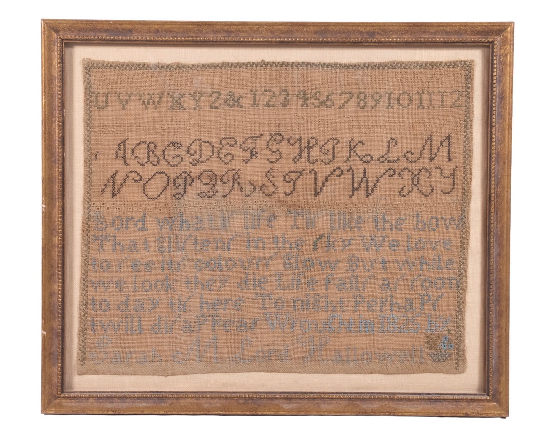SARAH M. LORD AMERICAN SAMPLER, DATED 1825: A linen alphabet and verse sampler worked in blue and tan threads, featuring multiple rows of upper- and lower-case alphabets, numerals, and a moral verse. Signed “Sarah M. Lord, Hallowell”