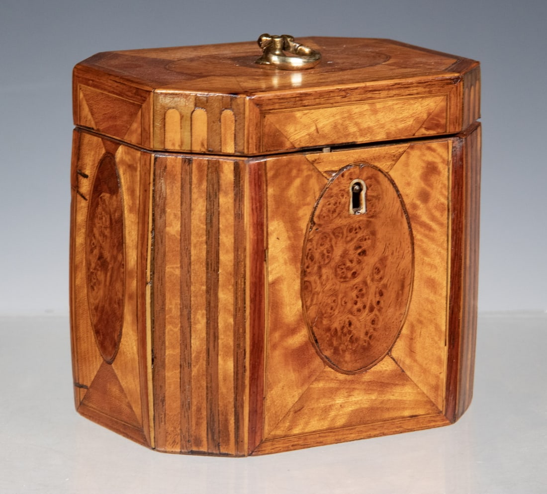 GEORGE III INLAID SATINWOOD OCTAGONAL TEA CADDY: English Late 18th - Early 19th c. Tea Box, eight sided form with inlaid oval burlwood panels and parquetry corners, brass escutcheon with key, with single lidded interior compartment, felted base.5