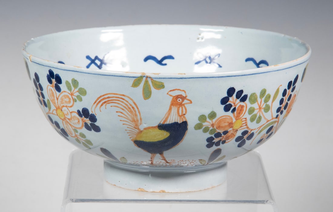 18TH C. ENGLISH DELFT POLYCHROME BOWL: Circa 1720 Vauxhall London Glazed Earthenware Bowl, the exterior with hand painted floral and rooster decoration in green, red, blue and yellow, the interior with blue painted foliage motifs, set on