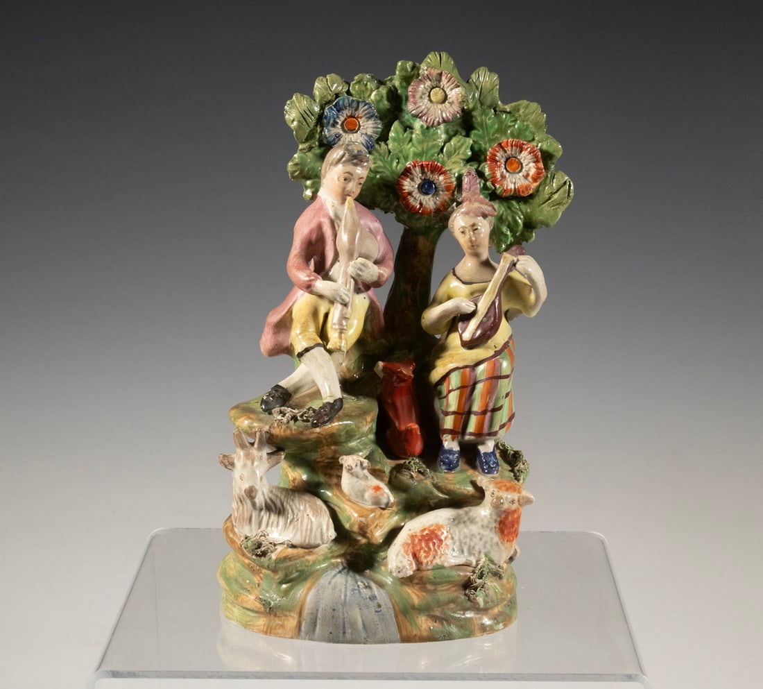 STAFFORDSHIRE PEARLWARE FIGURAL GROUP OF SHEPHERDS AND ANIMALS, C. 1825 (1 of 2)