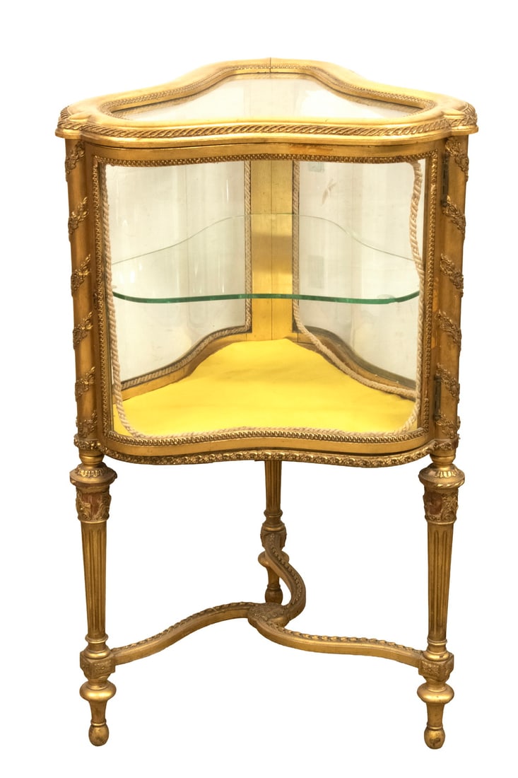 19TH C. LOUIS XVI STYLE GILTWOOD VITRINE: Late 19th century Display Table, probably French. An unusual triangular form with clear glass top and serpentine glass sides. The interior lined in lemon yellow silk fitted with a single plate glass