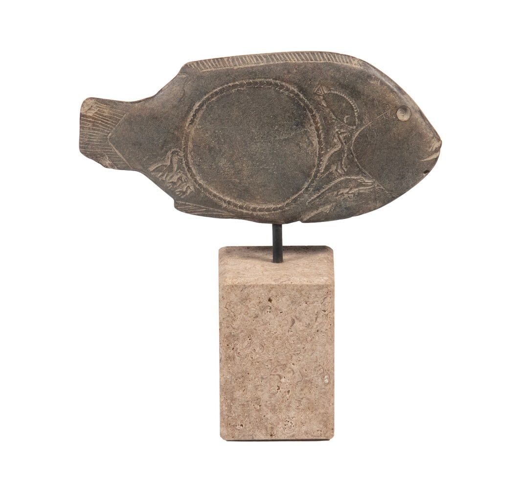 PREDYNASTIC EGYPTIAN COSMETIC PALETTE IN FORM OF FISH: Egyptian. Predynastic Period, Nadaqa II. 3650–3300 B.C. Carved stone grave offering in the shape of the bolti fish, or Tilapia nilotica, a type of edible fish from the Nile River that were