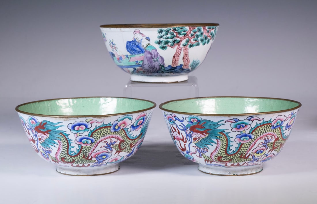 (3) CHINESE ENAMEL BOWLS: Comprising a pair of matching exterior designs of dragons chasing flaming pearls, featuring celadon enamel interiors, and a single bowl with figural and floral decoration on white ground. All with an