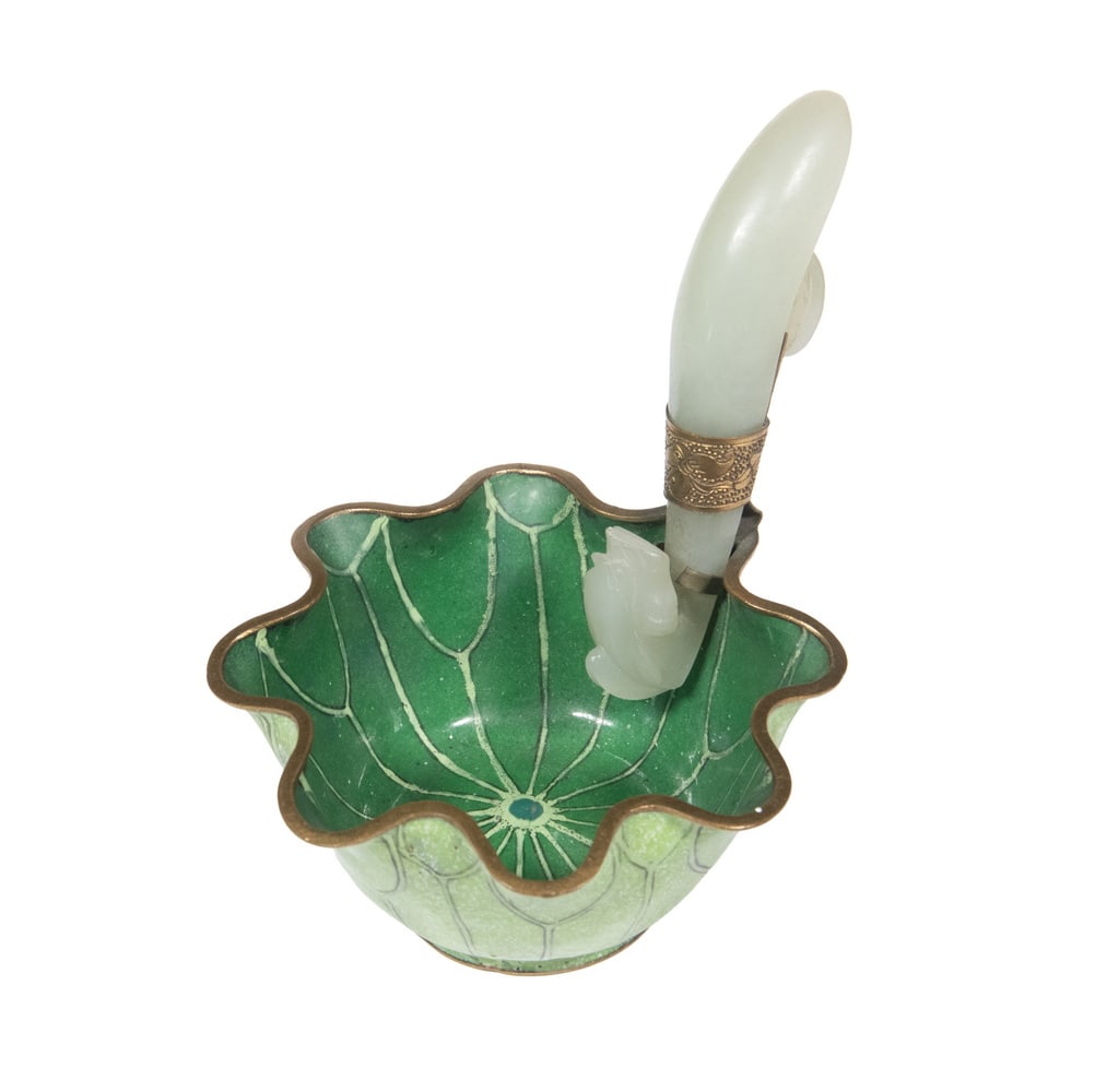 CHINESE CLOISONNE WATER DROPPER WITH JADE DRAGON HOOK, EARLY 20TH CENTURY: A lotus leaf-form cloisonné enamel water dropper in mottled green tones, fitted with a carved pale jade dragon-form belt hook secured by a gilt metal mount.Size: 3 3/4 x 4 x 3 1/4 in. (9.5 x