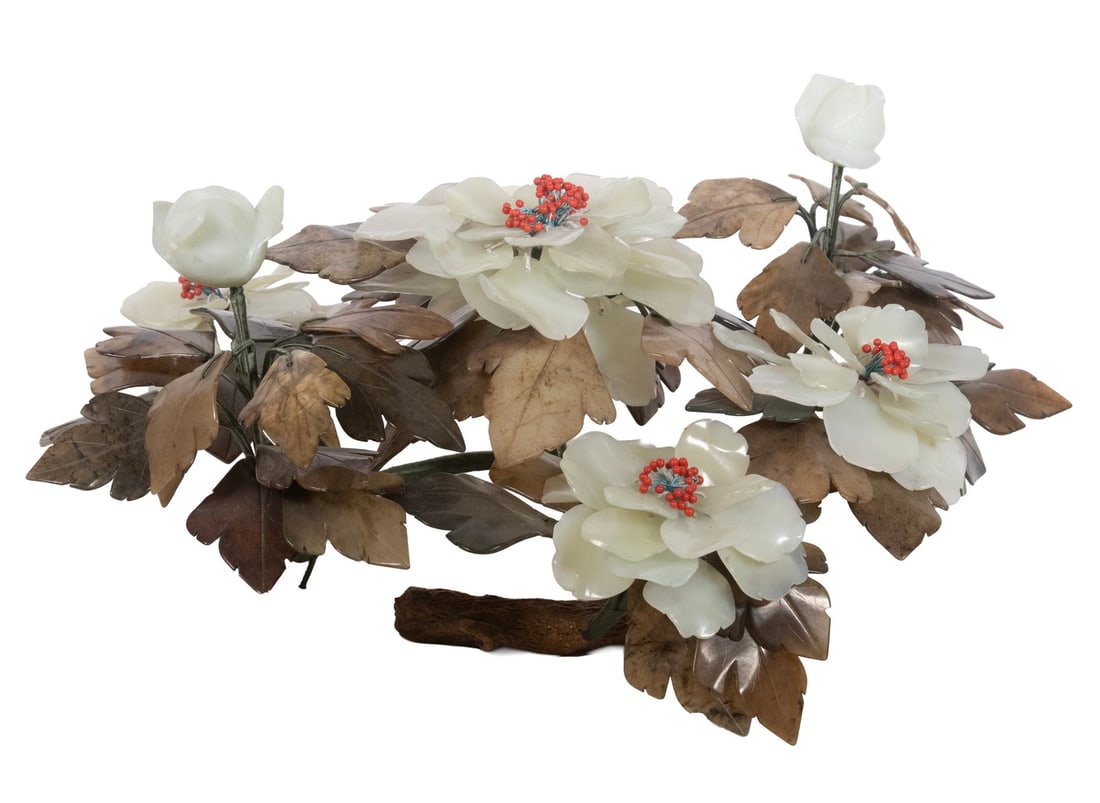 CHINESE JADE PEONY ARRANGEMENT, EARLY 20TH CENTURY: A decorative peony arrangement featuring carved jade petals in creamy white tones with red coral like bead stamens, set among brownish jade leaves. Designed as a low, spreading floral composition.7