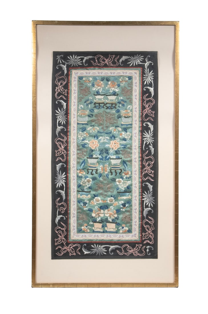 CHINESE EMBROIDERED SILK PANEL WITH AUSPICIOUS MOTIFS, 19TH CENTURY: An embroidered silk panel depicting floral sprays in jardinières, interspersed with auspicious motifs possibly including Daoist or symbolic emblems. Executed in satin stitch with areas of forbidd