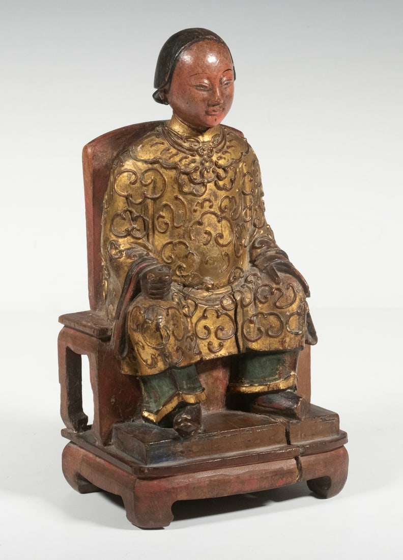 CHINESE ANCESTRAL CARVING, 18TH CENTURY: Qing Altar Figure of a Seated Matriarch, in carved and gilt wood, depicted with her hands resting on her knees, shrinkage crack, nice patina.8 3/4 x 4 3/4 x 3 1/2 in. (22.2 x 12.1 x 8.9 cm.)
