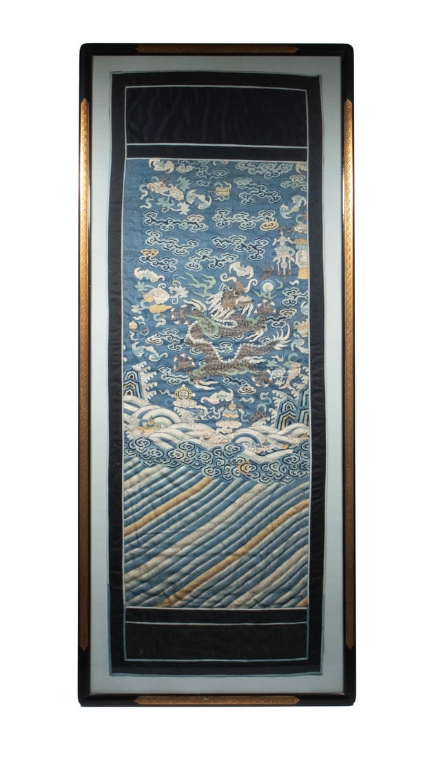 CHINESE KESI SILK PANEL WITH DRAGON AND BUDDHIST EIGHT TREASURES, 19TH CENTURY: A finely woven Chinese kesi panel depicting a five-clawed dragon emerging from stylized waves amid clouds, flaming pearl, and Buddhist Eight Treasures (Bajixiang). Woven in muted tones of blue,