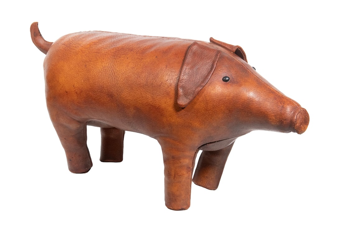 DMITRI OMERSA LEATHER PIG OTTOMAN: Vintage Leather Footstool, unmarked but likely by UK maker Dmitri Omersa for retailer Abercrombie & Fitch, in the form of a standing pig with curly tail. OS: 13 1/2 x 27 1/2 x 9 in. (34.3 x 69.9 x 22.