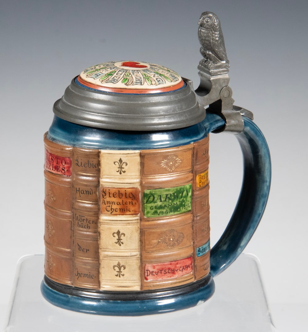 METTLACH "BOOK SPINES FOR NATURAL SCIENTISTS" STEIN: Pewter Mounted German 1/2-Liter Ceramic Stein, by Mettlach from their occupational series, design attributed to Otto Hupp, in relief molded and etched pottery, with inlaid lid, owl form thumb-lift,