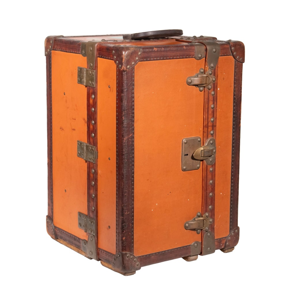 LOUIS VUITTON ORANGE VUITTONITE CANVAS LIBRARY TRUNK, C 1920s: A rare vertically oriented Louis Vuitton library trunk, constructed of orange Vuittonite canvas with brass hardware (the orange toning may in part reflect later maintenance or surface repainting),