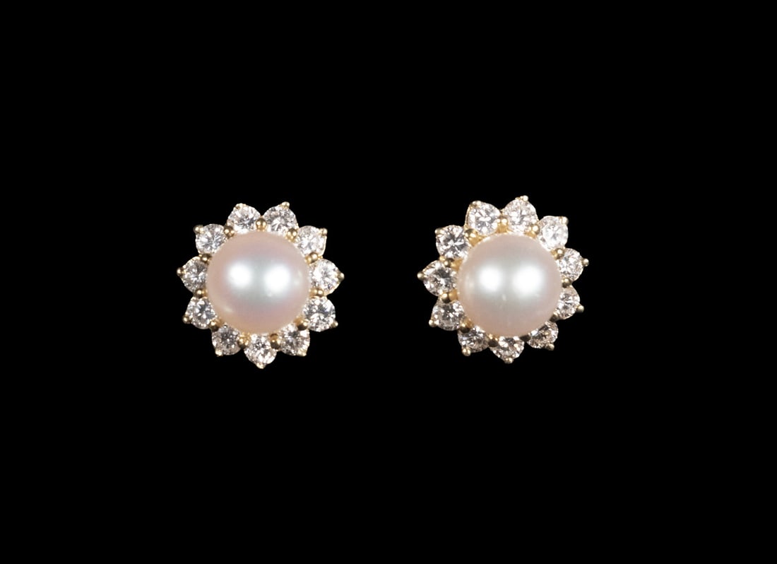 PR 18K YELLOW GOLD PEARL AND DIAMOND EARRINGS: A pair of 18K yellow gold earrings, each set with an approx. 8mm round cultured pearl with soft pink cream tone framed by a halo of (11) round brilliant-cut diamonds. Fitted with omega backs for secur