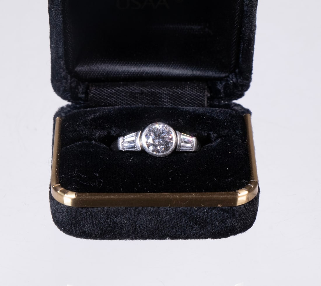 VINTAGE PLATINUM AND 1.11CT DIAMOND ENGAGEMENT RING: A hand-fabricated platinum ring bezel-set with one major round brilliant-cut diamond weighing approximately. 1.11ct, measuring 6.71–6.75 × 4.09mm, graded E color and SI1 clarity with excell