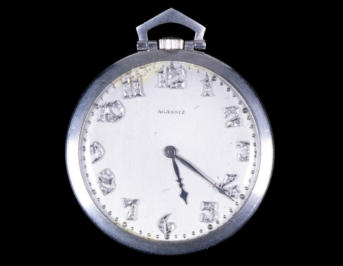 AGASSIZ PLATINUM ART DECO POCKET WATCH: Platinum case with diamond-set numerals. Movement serial no. 127151; running condition, minor discoloration between 11 and 12 o'clock position. Diameter: 1 5/8 in. (4.1 cm.)