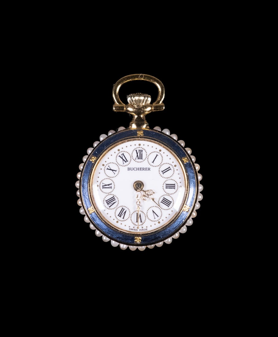 VINTAGE BUCHERER 18K GOLD SWISS PENDANT WATCH: A Bucherer pendant watch, designed as a round jewelry timepiece, featuring a white dial with Roman numeral hour markers and subsidiary minute track, signed “Bucherer” and “Swiss Made