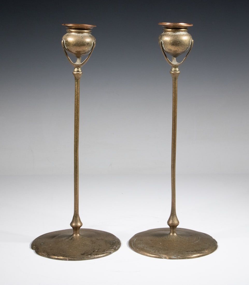 PR TIFFANY STUDIOS BRONZE CANDLESTICKS: Pair of Early 20th c. Art Nouveau Gilt Bronze Candleholders by Tiffany Studios, New York, each with an urn form candle cup with removable bobeche and set on a tall, slender shaft, each stamped