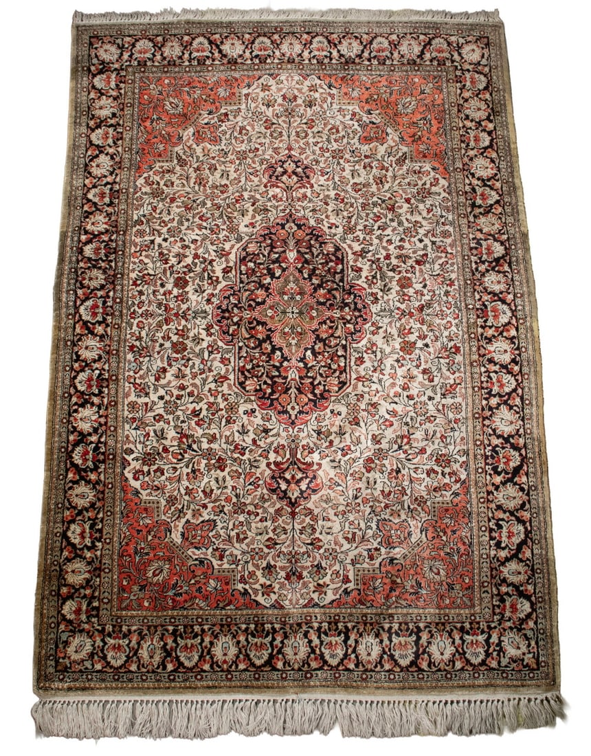 SILK TABRIZ RUG (3'5" X 5'3"): From Northwest Persia, made in the last quarter of the 20th Century. Features a midnight blue elongated hexagonal medallion set on an ivory field filled with flowering vine and palmettes in red,