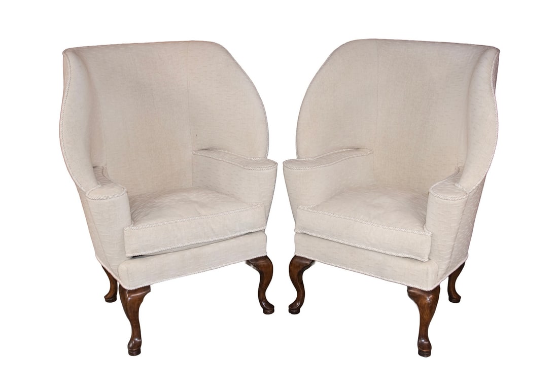 MINTON-SPIDELL PAIR OF CUSTOM BARRELBACK WING CHAIRS IN RAW COTTON, FROM L.A.: Pair of English Inn Valet's Wingchairs in raw cotton upholstery for William Switzer, with typical enveloping hood for shelter at entrance to Inn, cream colored with roped cording, raised on short