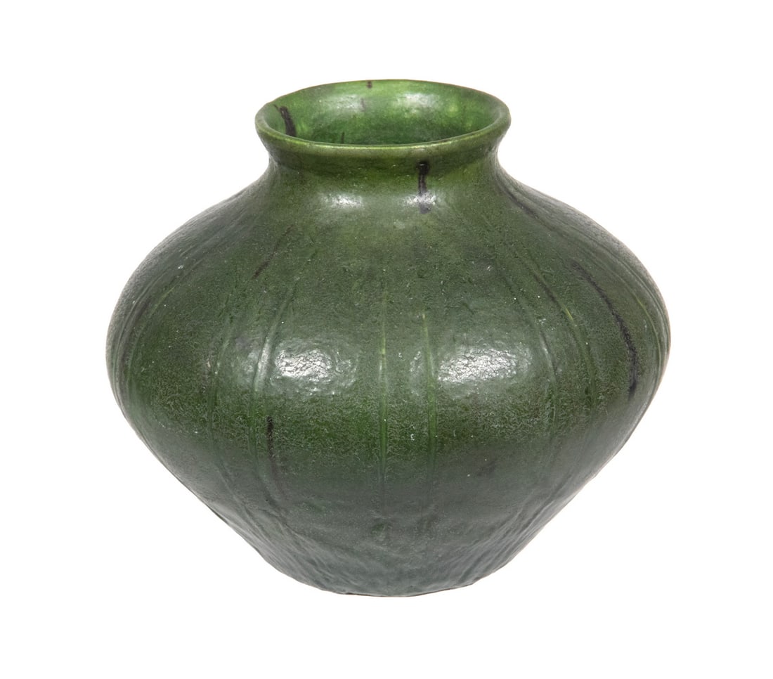 MEDIUM SIZED GRUEBY VASE CIRCA 1905: Low Squat Vase with small flared opening, in narrow leaf pattern of thick green faience tin glaze, with impressed mark on bottom.OS: 6 x 6 1/4 x 6 1/4 in. (15.2 x 15.9 x 15.9 cm.)