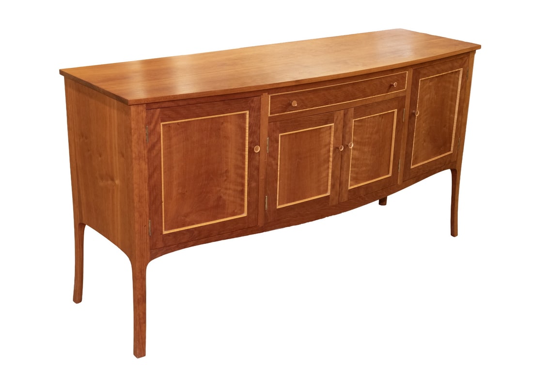 DAVID MARGONELLI CHERRY SIDEBOARD FROM EDGECOMB, ME: Custom Hand Crafted Bowfront Dining Room Cabinet, in solid cherry by Maine cabinetmaker David Margonelli (1942-2011), with overhanging top and contrasting figured maple drawer and cabinet door trim, h