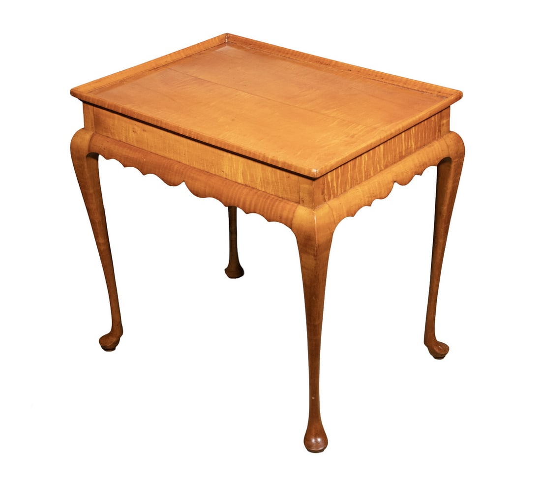 LATE 19TH C. TIGER MAPLE NANTUCKET TEA TABLE: Low Rectangular Table in tiger maple with orange shellac finish, peg construction, having recessed molded top, flat skirt with quarter round lobed bottom edge, raised on slender round tapered legs