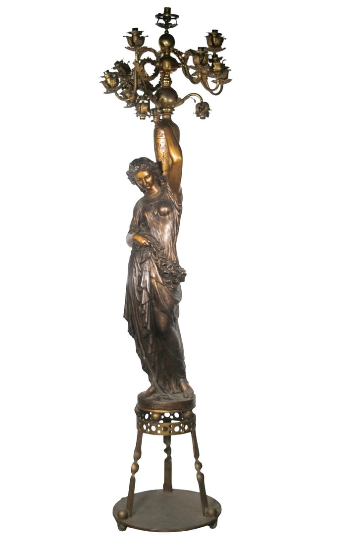 NEOCLASSICAL BRONZED CAST IRON LIFE SIZE FIGURAL FLOOR CANDELABRA: Circa 1867-1870 French Figural Chandelier by Fourment-Houille & Cie. Foundry. Val d”Osne, France. Cast as a Grecian water carrier, the patinated iron figure is attired in a flowing robe with flo