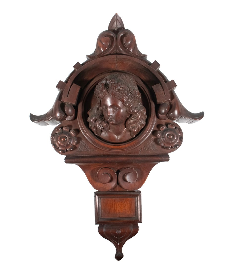FINE GILDED AGE CARVED FIREPLACE MANTEL CREST: Architectural Scale Mahogany Carving with Romanesque Surround, centered on a round framed head of a Woman wearing a Laurel Wreath, solid back. OS: 31 x 22 x 9 in. (78.7 x 55.9 x 22.9 cm.)