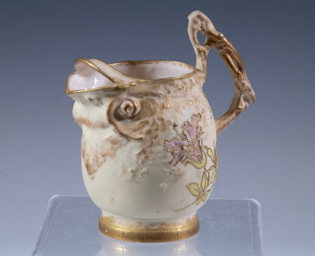 AUSTRIAN ART NOUVEAU FISH-FORM CREAMER BY RSTK, C.1900: AUSTRIAN ART NOUVEAU FISH-FORM CREAMER BY RSTK, C.1900A finely modeled and hand-painted porcelain creamer in the shape of a stylized fish, with textured body, exaggerated fins forming the spout, and a