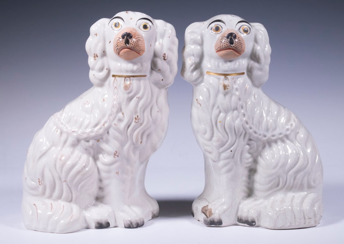 PR STAFFORDSHIRE SEATED SPANIELS: PR STAFFORDSHIRE SEATED SPANIELS Pair of Late 19th c. English Glazed Pottery Dog Figurines, with painted faces, molded fur and chain, gilded highlights, embossed "2" on base. One with hairline