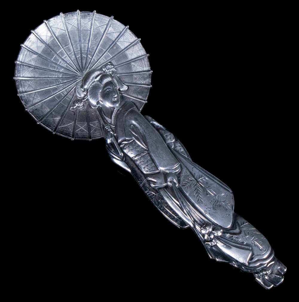 JAPANESE STERLING FIGURAL SPOON: JAPANESE STERLING FIGURAL SPOON Sterling Silver Spoon, in the form of a standing Geisha with umbrella, by Arthur & Bond, Yokohama. 1.54 ozt. Length: 6 1/4 in. (15.9 cm.)
