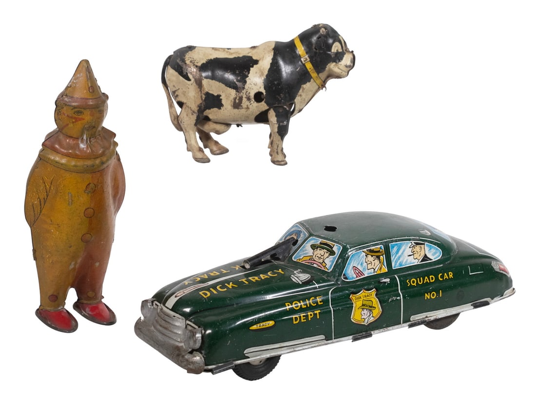 (3) VINTAGE TIN TOYS: (3) VINTAGE TIN TOYS A group of three tin toys including a large Dick Tracy Squad Car No.1 marked MARX / Made in United States of America ; a wind-up tin cow marked MADE IN JAPAN ; and a painted tin J