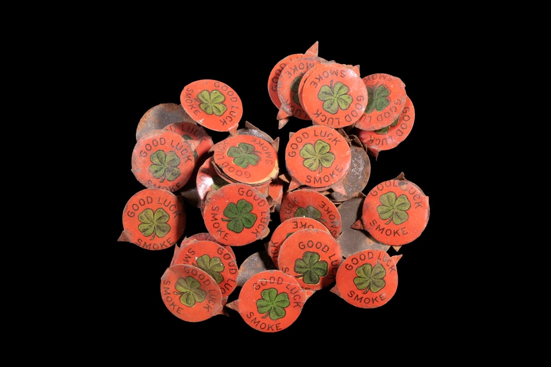 (44) ANTIQUE TIN TOBACCO TAGS, GOOD LUCK SMOKE: (44) ANTIQUE TIN TOBACCO TAGS, GOOD LUCK SMOKE A group of 44 pressed tin tobacco tags, each painted bright red and decorated with a central green four-leaf clover, inscribed GOOD LUCK SMOKE . Such