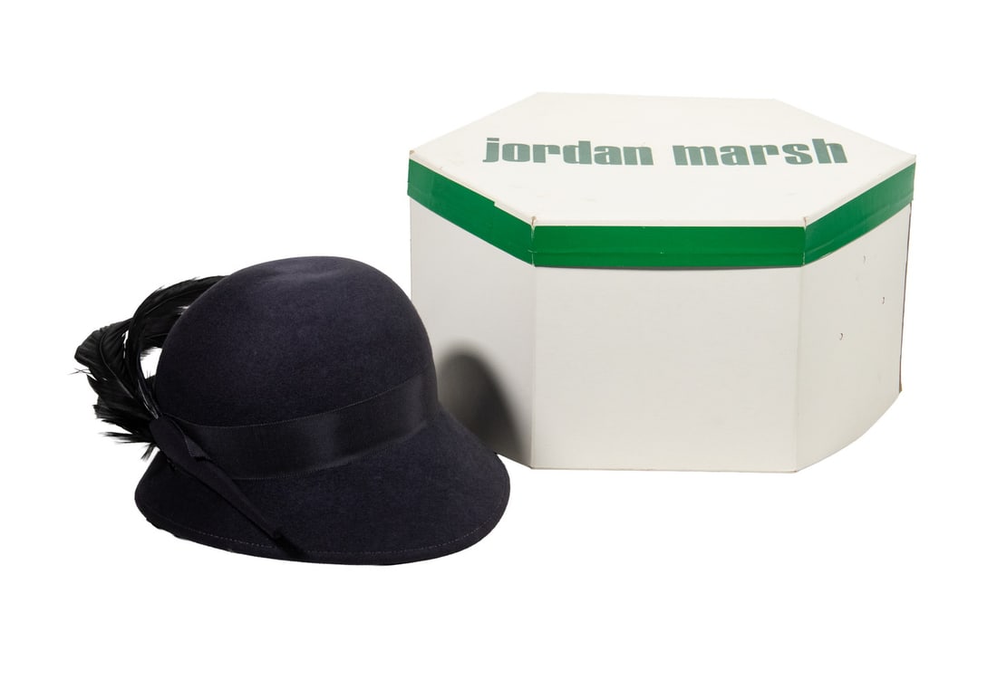 ADOLFO II FEATHER-TRIMMED WOOL FELT HAT WITH ORIGINAL JORDAN MARSH BOX: ADOLFO II FEATHER-TRIMMED WOOL FELT HAT WITH ORIGINAL JORDAN MARSH BOX A vintage dark grey wool felt hat by Adolfo II, New York, featuring an elegant spray of long black feathers along one side.