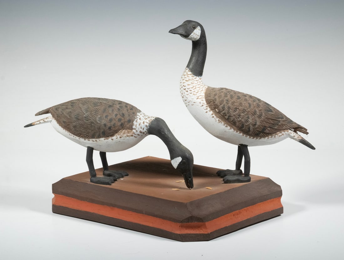 SCULPTURE OF TWO CANADA GEESE ON PLINTH: SCULPTURE OF TWO CANADA GEESE ON PLINTH Carved and painted wood, one feeding, one on alert. Unsigned by either Vincent Viennotte or his son, Dominique Viennotte. From the estate of Larry and Jean