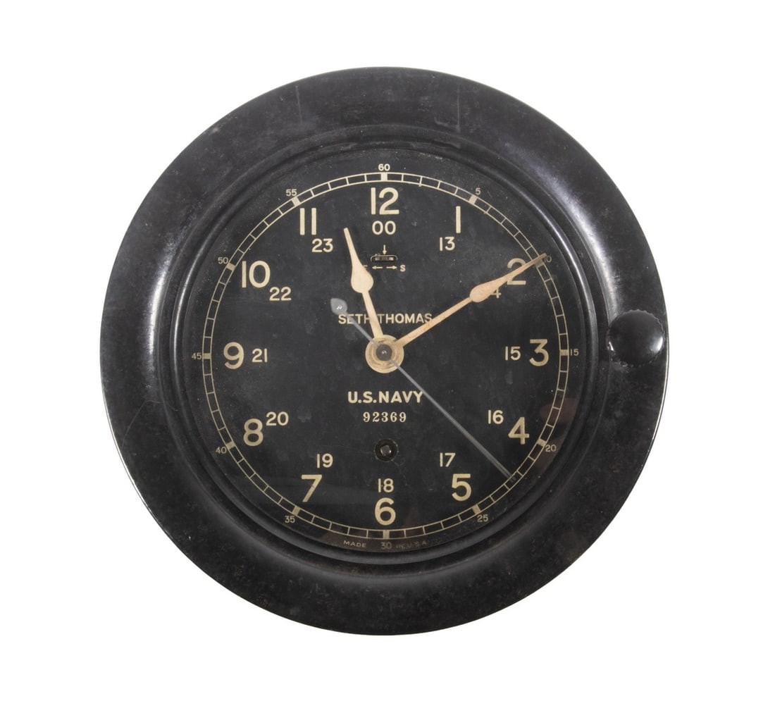 SETH THOMAS WWII ERA US NAVY SHIP'S CLOCK: SETH THOMAS WWII ERA US NAVY SHIP'S CLOCK Mark I Deck Clock, S/N 92369, in a black phenolic case, having a 5 1/2" black face dial with white 12/24 Arabic numerals, hinged bezel with thumbscrew