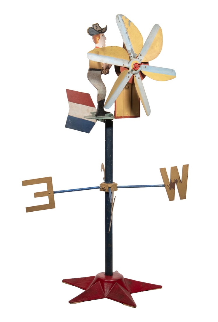 COWBOY THEMED METAL WHIRLIGIG: COWBOY THEMED METAL WHIRLIGIG Windmill being Turned by a Cowboy, in painted steel with directionals and star form base. Size: 28 1/2 x 18 x 18 in. (72.4 x 45.7 x 45.7 cm.)