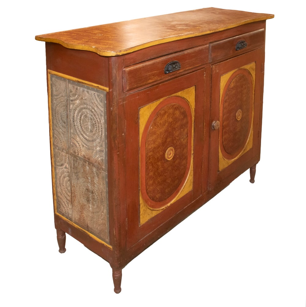 CIRCA 1830 COUNTRY PAINTED LOW CUPBOARD: CIRCA 1830 COUNTRY PAINTED LOW CUPBOARD American Rustic Storage Cabinet, with grain painted shaped top and punched tin side panels, topped with two drawers with iron pull handles, two cabinet doors