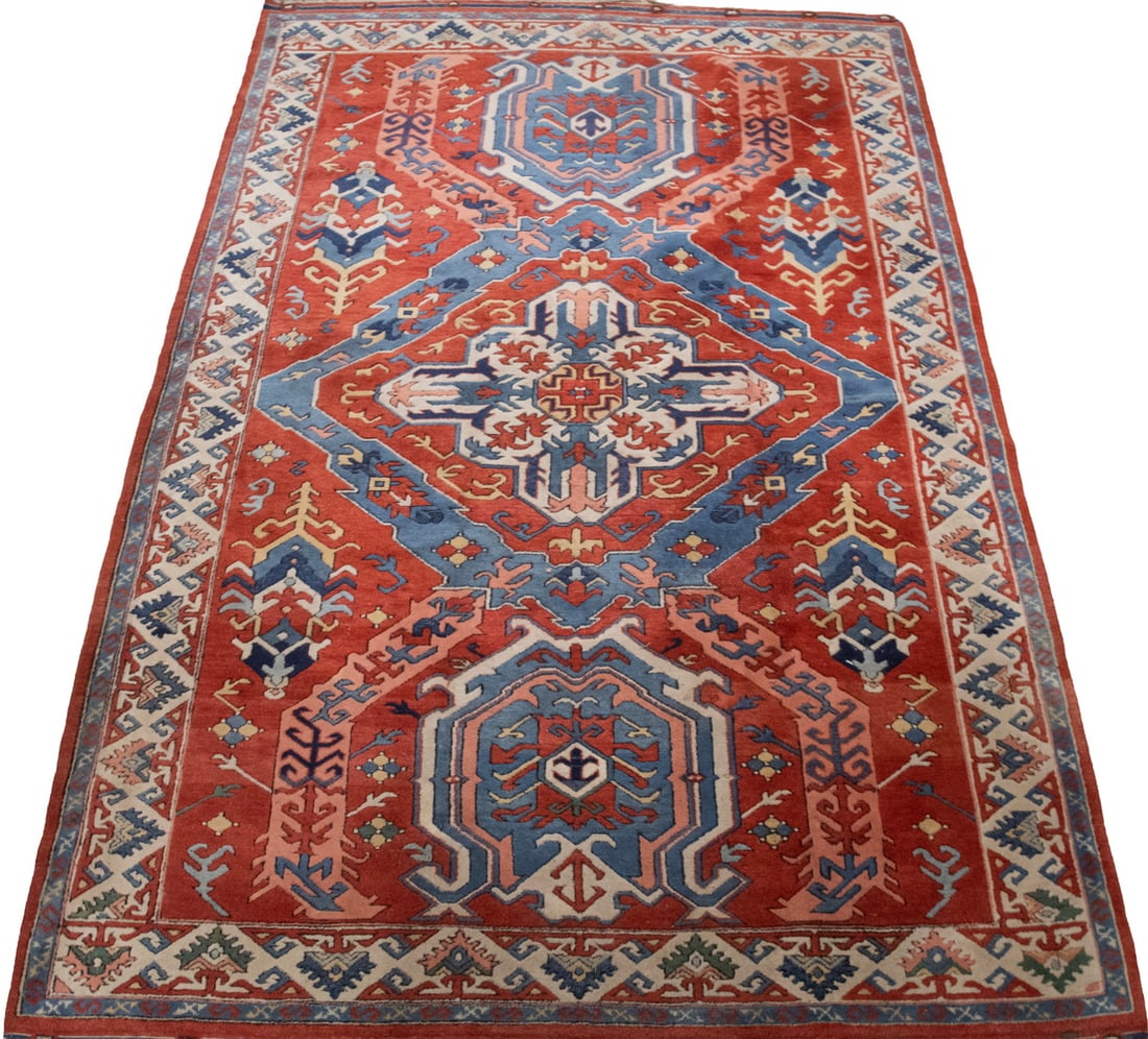 KAZAK STYLE CARPET (5'9" X 9'2"): KAZAK STYLE CARPET (5'9" X 9'2") From Northwest Pakistan, made in the late 20th Century. Features concentric notched diamond medallions in rust-red, Persian blue, gold, rose and ivory on the rust-red