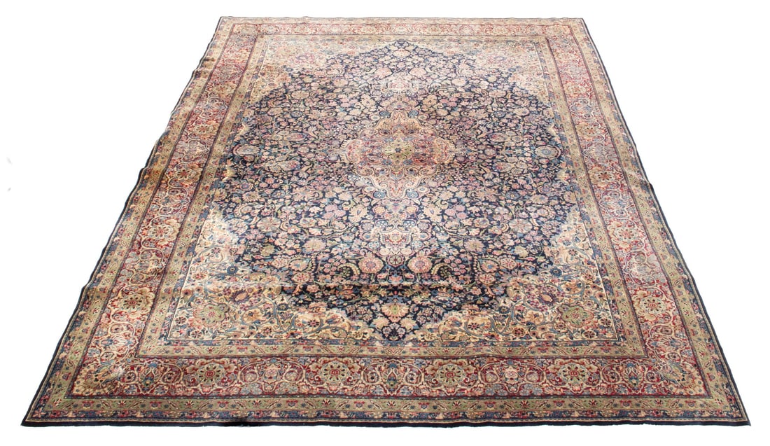 KASHAN RUG (10' x 14'3"): KASHAN RUG (10' x 14'3") An offering of a beautiful Persian rug. Features a large central medallion decorated with vines, floral motifs, and palmettes in red, pink, light blue, and green on the dark