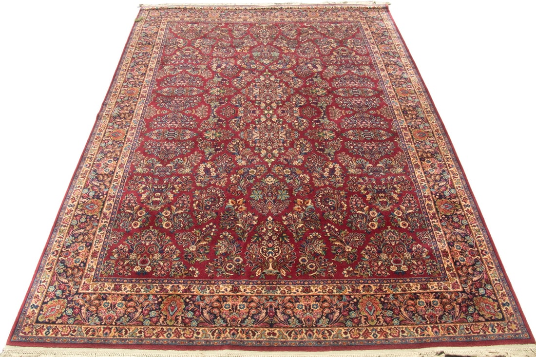 RED SAROUK (14'2"x10'): RED SAROUK (14'2"x10') An offering of a large Sarouk-style rug. It features a red field with two central medallions surrounded by palmettes and floral motifs with a blue floral & vine palmette