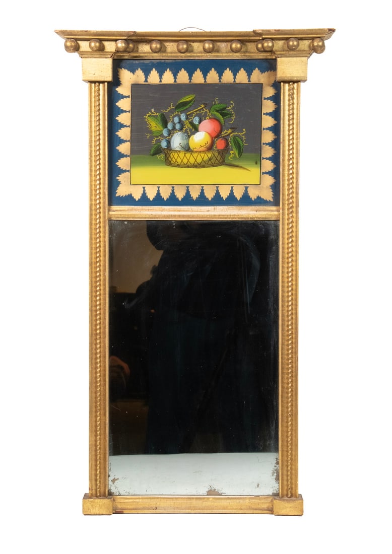 FEDERAL PERIOD GILT MIRROR W/ EGLOMISE THEOREM: FEDERAL PERIOD GILT MIRROR W/ EGLOMISE THEOREM Naive Reverse Painted Basket of Fruit in molded and beaded frame with etched corner blocks, 14-sphere cornice, retaining early grey silvering. Size: 28