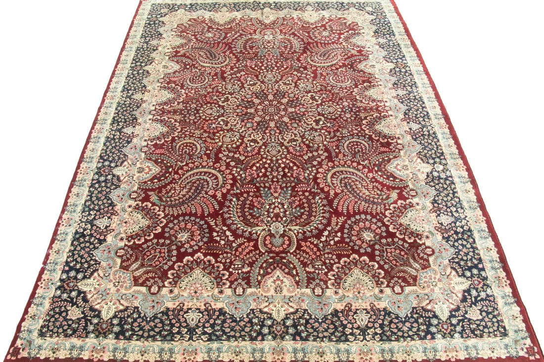 CONTEMPORARY TABRIZ RUG (14'7" x 9'11"): CONTEMPORARY TABRIZ RUG (14'7" x 9'11") An offering of a contemporary Tabriz-style rug. The red field is covered in repeating vine and floral designs with a deep navy blue floral border. Overall