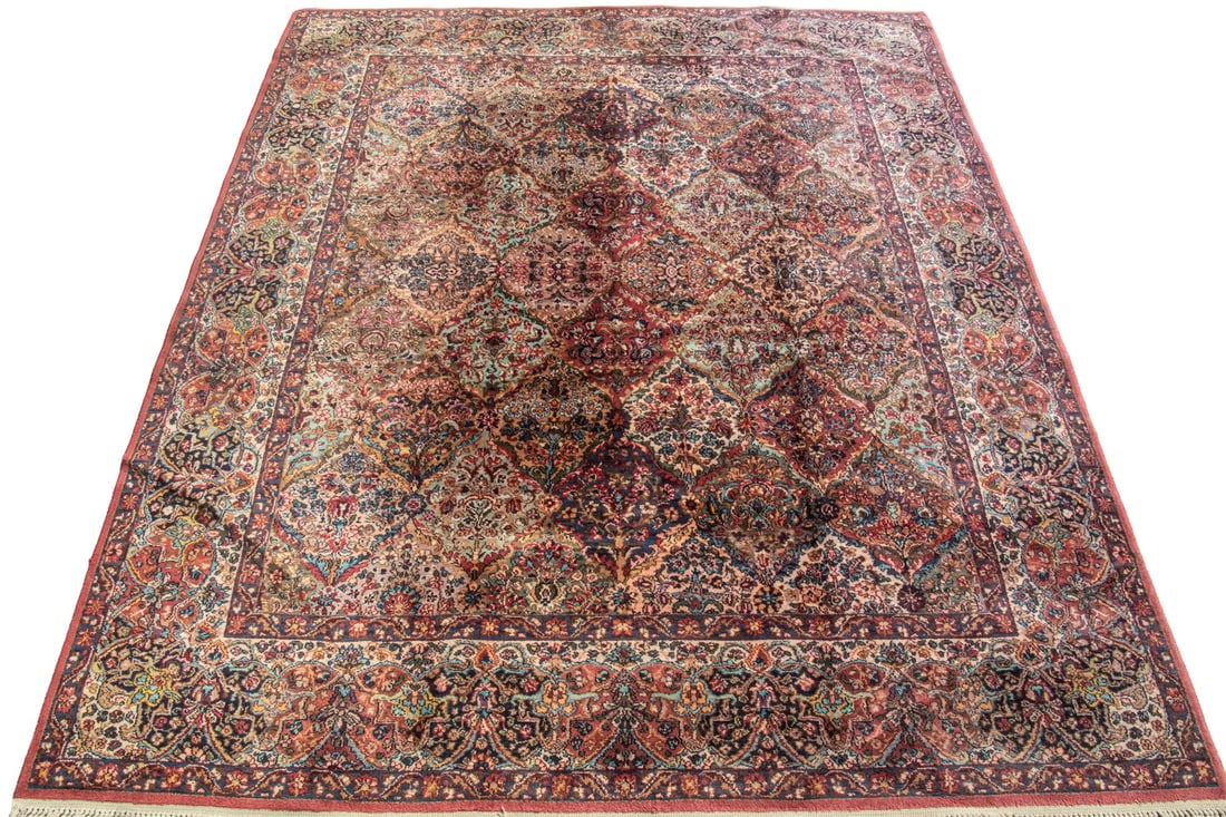 KARASTAN CARPET (8'8" x 10'6"): KARASTAN CARPET (8'8" x 10'6") A Lavar Kirman Persian design, featuring an overall diamond lattice design in ivory, gold, red, sky blue, midnight blue and aubergine with a midnight blue and red