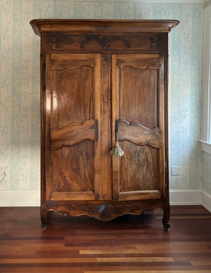 18TH C. FRENCH PROVENCIAL ARMOIRE: 18TH C. FRENCH PROVENCIAL ARMOIRE Louis XV Style, in figured walnut and elm, with deep molded crown, curvilinear molded panel doors, carved and shaped skirt, raised on squat cabriole legs ending in pa