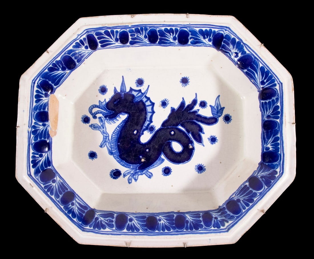 17 TH C. DUTCH EARLY DELFTWARE BASIN: 17TH C. DUTCH EARLY DELFTWARE BASIN Elongated Octagonal Wash Basin in thick blue majolica type glaze, featuring a single Griffin centered in bottom, floral band on the everted rim, heavy walled.