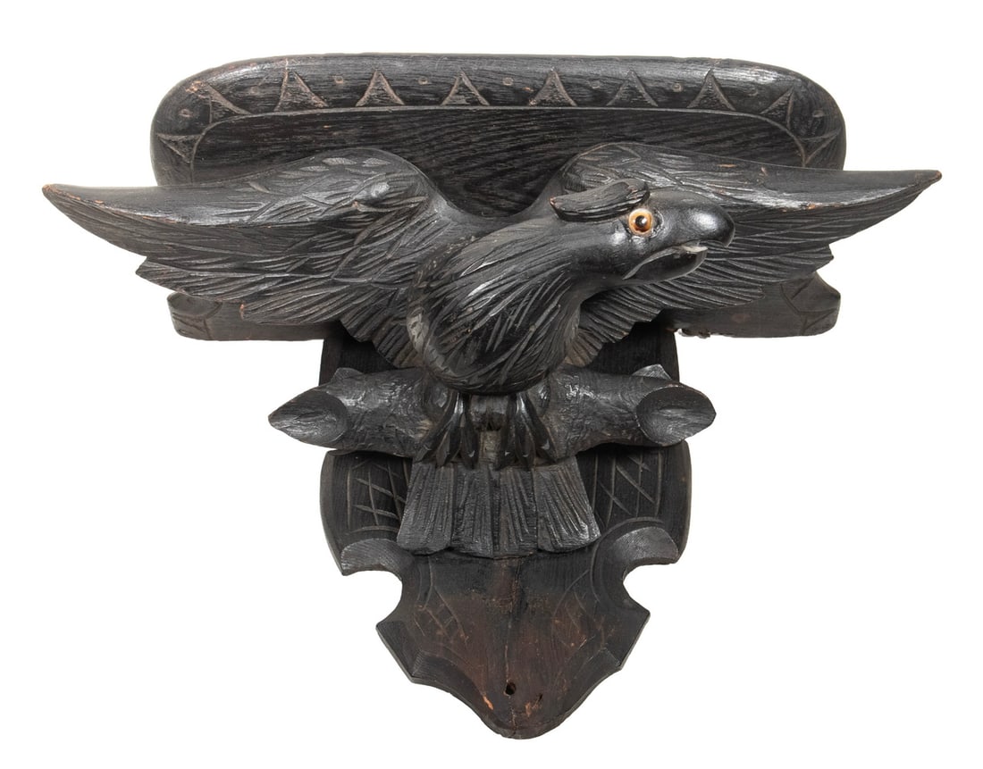 19TH C. GERMAN BLACK FOREST EAGLE BRACKET: 19TH C. GERMAN BLACK FOREST EAGLE BRACKET Spread wing Eagle Bracket Shelf, facing right, with glass eye, facing right, the rectangular shelf molded with rounded corners. Size: 11 1/2 x 8 1/2 x 15 1/2