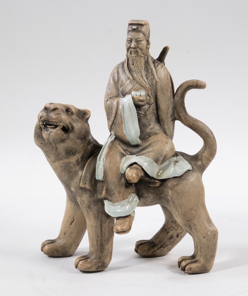 CHINESE SHIWAN PORCELAIN FIGURINE: CHINESE SHIWAN PORCELAIN FIGURINE Porcelain Figurine Depicting Wen Shu, representing wisdom and depicted riding a lion, unglazed surface other than the edges of his robe, unmarked, in a fitted silk-co